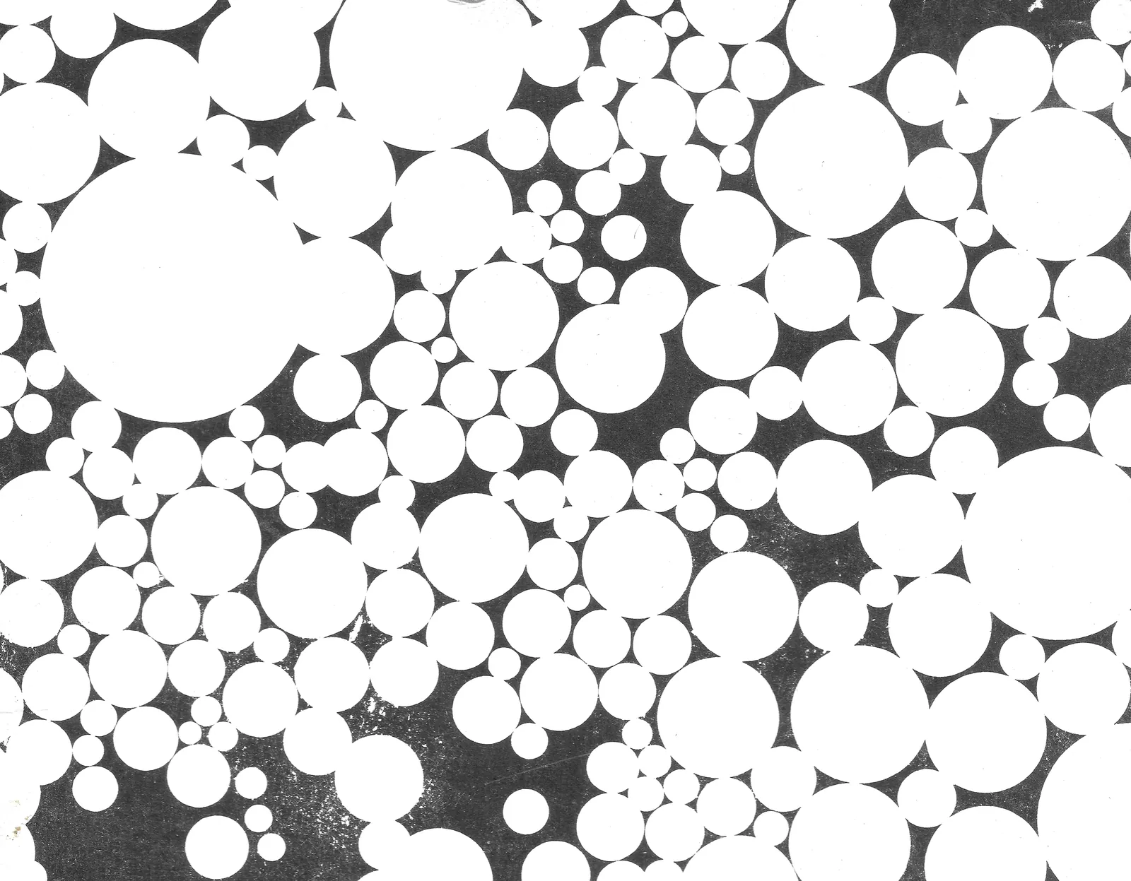 Scan of a black and white print with white circles of different sizes on a dark ground